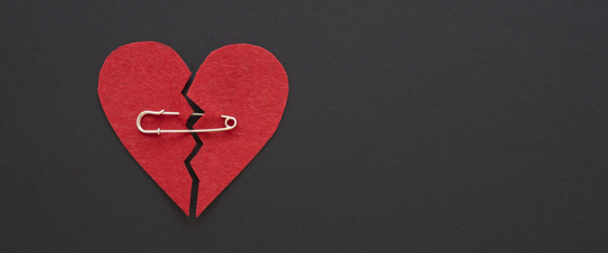 top-view-broken-heart-with-safety-pin