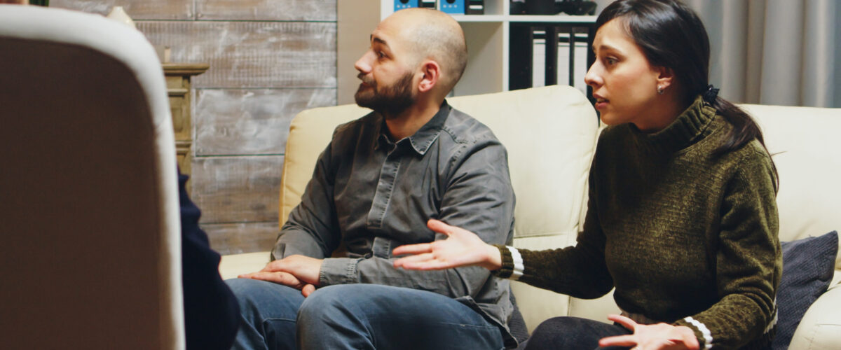 Zoom in shot of angry young wife at couples therapy. Psychologist in couple difficulties.
